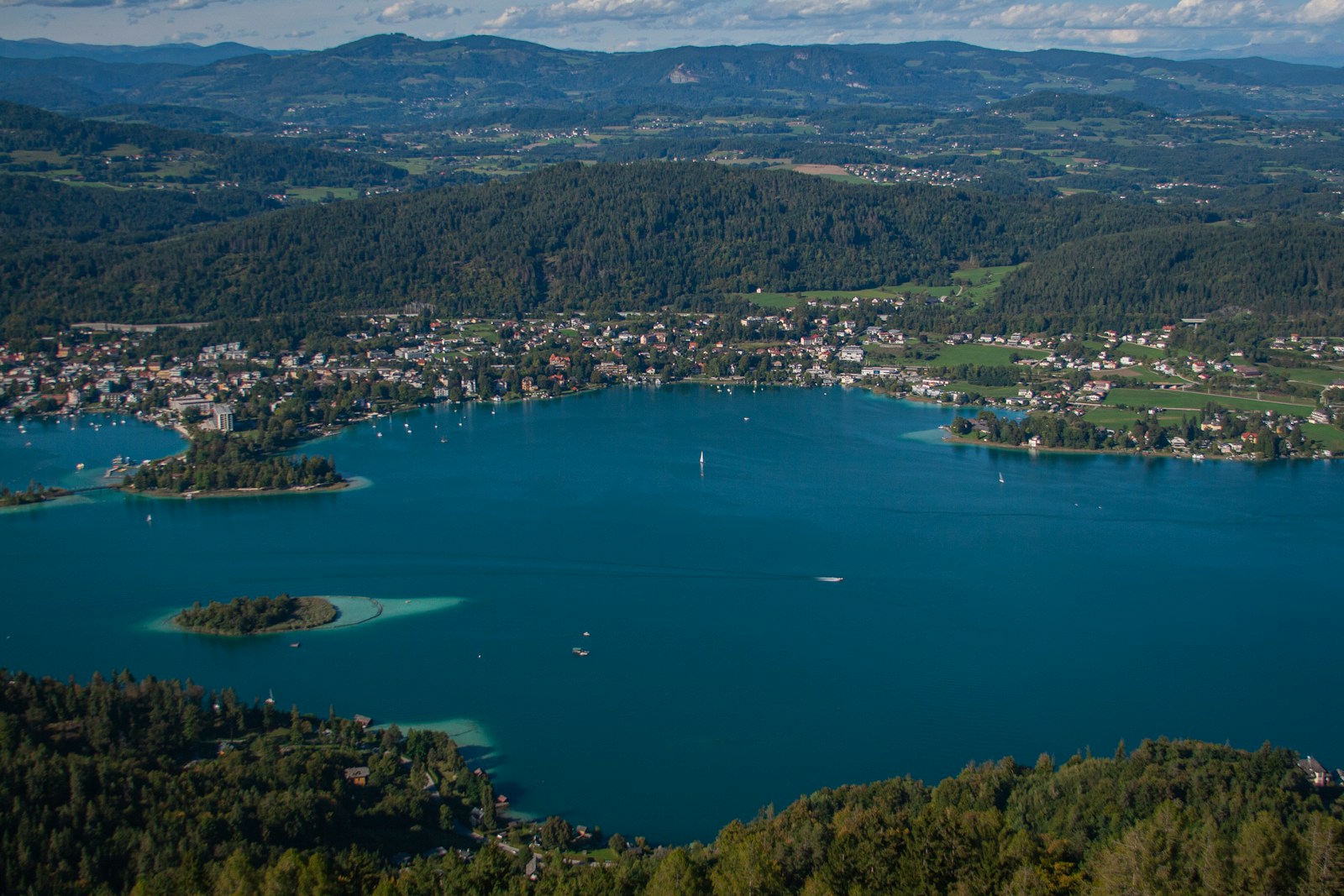 a body of water surrounded by trees and buildings